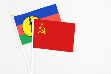 Soviet Union and New Caledonia stick flags on white background. High quality fabric, miniature national flag. Peaceful global concept.White floor for copy space.