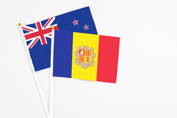 Andorra and New Zealand stick flags on white background. High quality fabric, miniature national flag. Peaceful global concept.White floor for copy space.