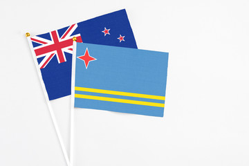 Aruba and New Zealand stick flags on white background. High quality fabric, miniature national flag. Peaceful global concept.White floor for copy space.