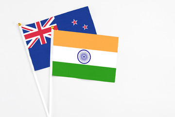 India and New Zealand stick flags on white background. High quality fabric, miniature national flag. Peaceful global concept.White floor for copy space.