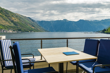 Fototapeta na wymiar Sunny view of Boka Kotor bay from coastal cafe near Perast, Montenegro.