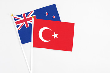 Turkey and New Zealand stick flags on white background. High quality fabric, miniature national flag. Peaceful global concept.White floor for copy space.