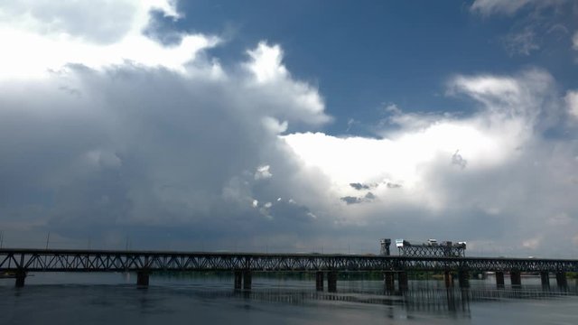 thunderclouds and bridge over the river