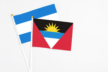 Antigua and Barbuda and Nicaragua stick flags on white background. High quality fabric, miniature national flag. Peaceful global concept.White floor for copy space.