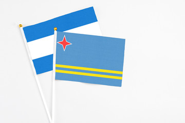 Aruba and Nicaragua stick flags on white background. High quality fabric, miniature national flag. Peaceful global concept.White floor for copy space.