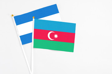 Azerbaijan and Nicaragua stick flags on white background. High quality fabric, miniature national flag. Peaceful global concept.White floor for copy space.