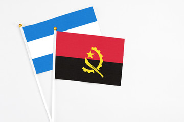 Angola and Nicaragua stick flags on white background. High quality fabric, miniature national flag. Peaceful global concept.White floor for copy space.