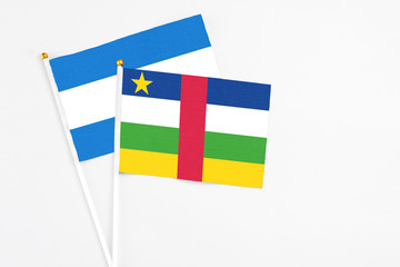 Central African Republic and Nicaragua stick flags on white background. High quality fabric, miniature national flag. Peaceful global concept.White floor for copy space.