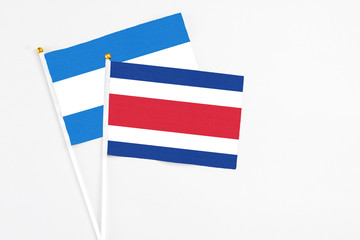 Costa Rica and Nicaragua stick flags on white background. High quality fabric, miniature national flag. Peaceful global concept.White floor for copy space.