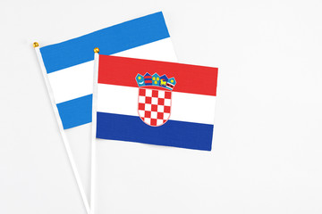 Croatia and Nicaragua stick flags on white background. High quality fabric, miniature national...