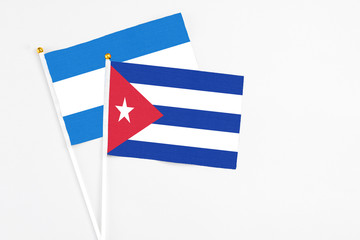 Cuba and Nicaragua stick flags on white background. High quality fabric, miniature national flag. Peaceful global concept.White floor for copy space.