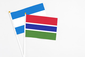 Gambia and Nicaragua stick flags on white background. High quality fabric, miniature national flag. Peaceful global concept.White floor for copy space.