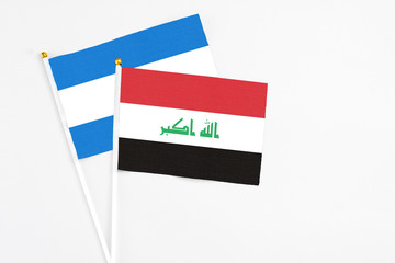 Iraq and Nicaragua stick flags on white background. High quality fabric, miniature national flag. Peaceful global concept.White floor for copy space.
