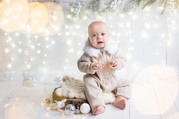 Obraz na płótnie Canvas a little boy in a beige Christmas suit. new year. child