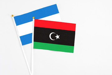 Libya and Nicaragua stick flags on white background. High quality fabric, miniature national flag. Peaceful global concept.White floor for copy space.
