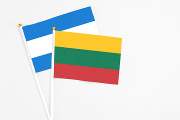 Lithuania and Nicaragua stick flags on white background. High quality fabric, miniature national flag. Peaceful global concept.White floor for copy space.