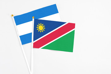 Namibia and Nicaragua stick flags on white background. High quality fabric, miniature national flag. Peaceful global concept.White floor for copy space.