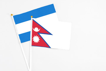 Nepal and Nicaragua stick flags on white background. High quality fabric, miniature national flag. Peaceful global concept.White floor for copy space.