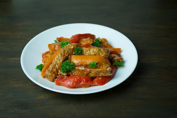 Bell pepper and meat salad. Colorful salad. Dark background. Space for text.