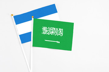 Saudi Arabia and Nicaragua stick flags on white background. High quality fabric, miniature national flag. Peaceful global concept.White floor for copy space.