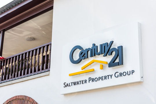 St. Augustine, USA - May 10, 2018: Sign For Century 21 Saltwater Property Real Estate Group And Nobody On Street Closeup In Florida City Historic Architecture