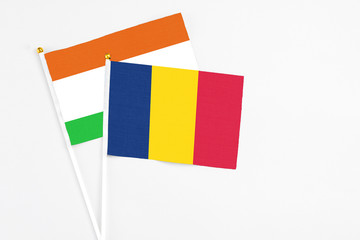 Chad and Niger stick flags on white background. High quality fabric, miniature national flag....