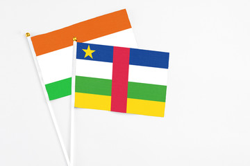 Central African Republic and Niger stick flags on white background. High quality fabric, miniature national flag. Peaceful global concept.White floor for copy space.