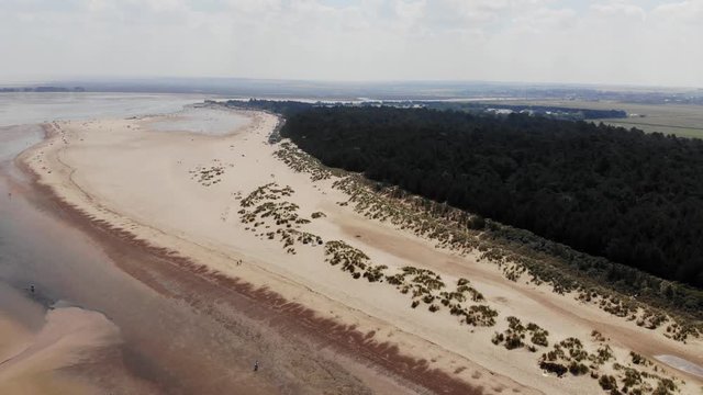 Aerial Landscape Beach, Dunes And Woodland North Norfolk UK Panning Out.