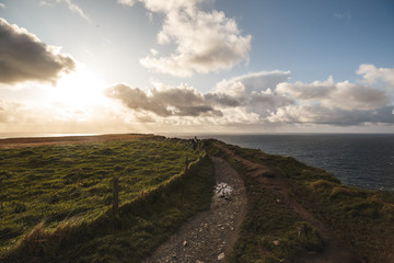 Fototapeta na wymiar Path of Cliffs of Moher with cloudscape