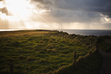 Path of Cliffs of Moher with cloudscape and sunshine