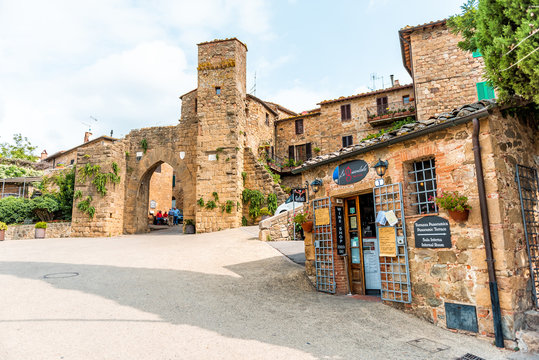 Monticchiello, Italy - August 26, 2018: Val D'Orcia countryside in Tuscany with empty street arch entrance in small town village with nobody