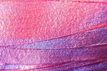 Macro photo. Paint of purple, red and pink shades close up. Abstract bright image of acrylic paint....