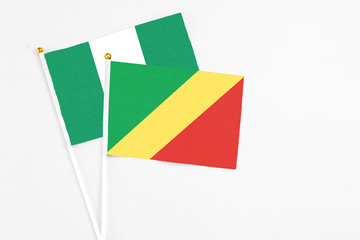 Republic Of The Congo and Nigeria stick flags on white background. High quality fabric, miniature national flag. Peaceful global concept.White floor for copy space.