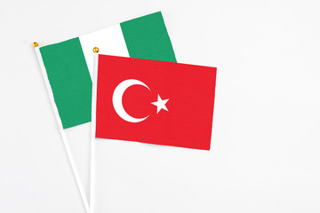 Turkey and Nigeria stick flags on white background. High quality fabric, miniature national flag. Peaceful global concept.White floor for copy space.