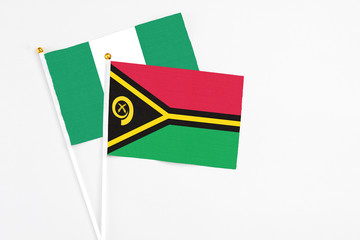 Vanuatu and Nigeria stick flags on white background. High quality fabric, miniature national flag....