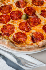 Close up of a pizza with fork and knife