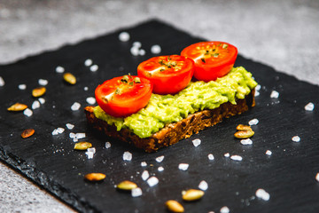 Healthy avocado toast with cherry tomatoes