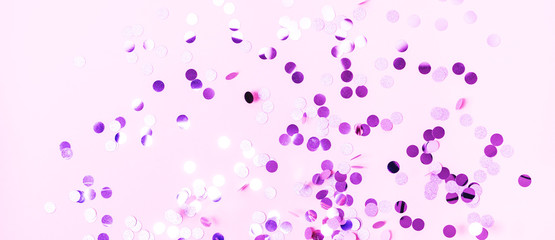 Different sparkles confetti flying on turquoise pastel background. The festive backdrop for your projects.