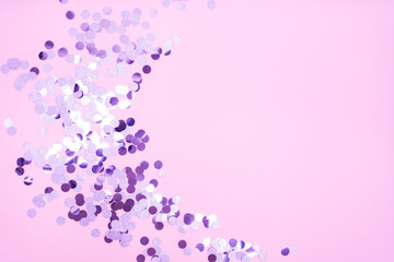 Different sparkles confetti flying on turquoise pastel background. The festive backdrop for your projects.