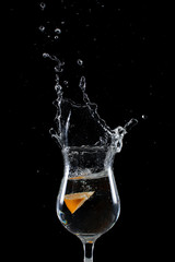 Orange Dropped Into a Glass with a Big Splash