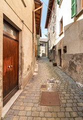 Fototapeta na wymiar Narrow street of mountain ancient village Zelbio, Italy