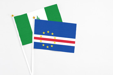 Cape Verde and Norfolk Island stick flags on white background. High quality fabric, miniature national flag. Peaceful global concept.White floor for copy space.