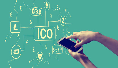 Cryptocurrency ICO theme with person holding a white smartphone