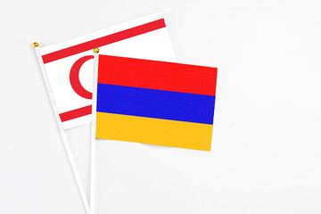 Armenia and Northern Cyprus stick flags on white background. High quality fabric, miniature national flag. Peaceful global concept.White floor for copy space.