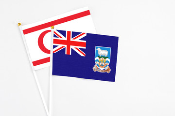 Falkland Islands and Northern Cyprus stick flags on white background. High quality fabric, miniature national flag. Peaceful global concept.White floor for copy space.