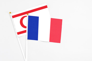 France and Northern Cyprus stick flags on white background. High quality fabric, miniature national flag. Peaceful global concept.White floor for copy space.