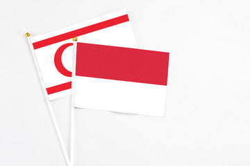 Indonesia and Northern Cyprus stick flags on white background. High quality fabric, miniature national flag. Peaceful global concept.White floor for copy space.