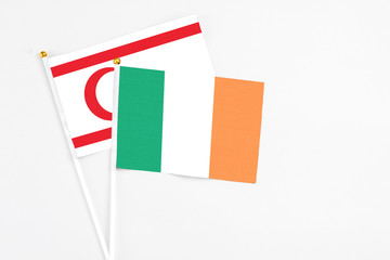 Ireland and Northern Cyprus stick flags on white background. High quality fabric, miniature national flag. Peaceful global concept.White floor for copy space.