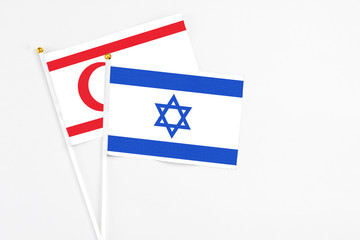 Israel and Northern Cyprus stick flags on white background. High quality fabric, miniature national flag. Peaceful global concept.White floor for copy space.