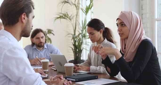 Asian muslim female manager consulting partner at group office meeting